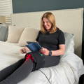 Woman holding Cura ProWave Deep Healing Pad