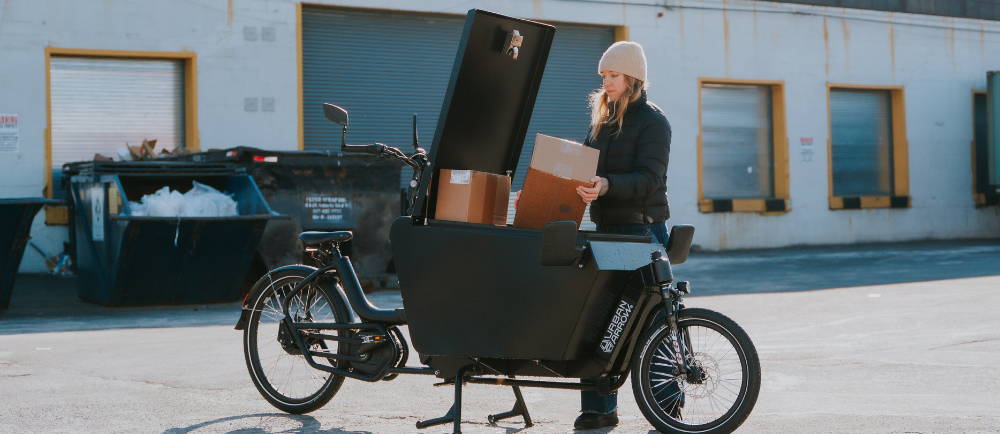 Rider loading boxes into Urban Arrow electric cargo bike