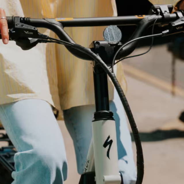 a woman riding a specialized electric cargo bike