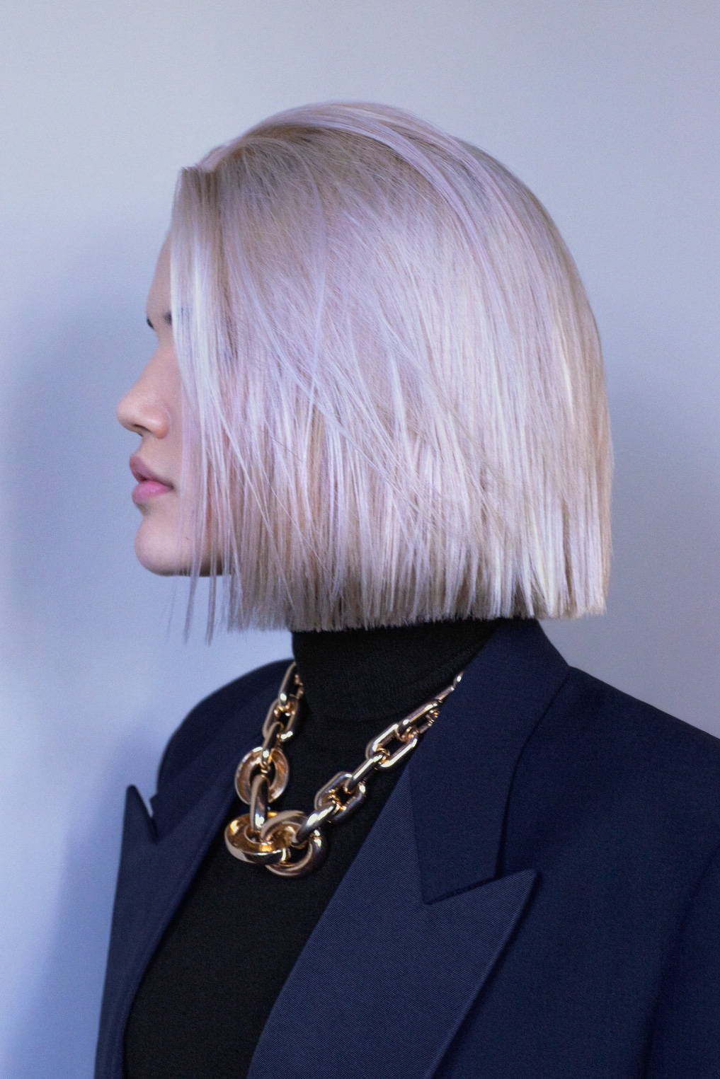 side view of a woman with a platinum bob hairstyle