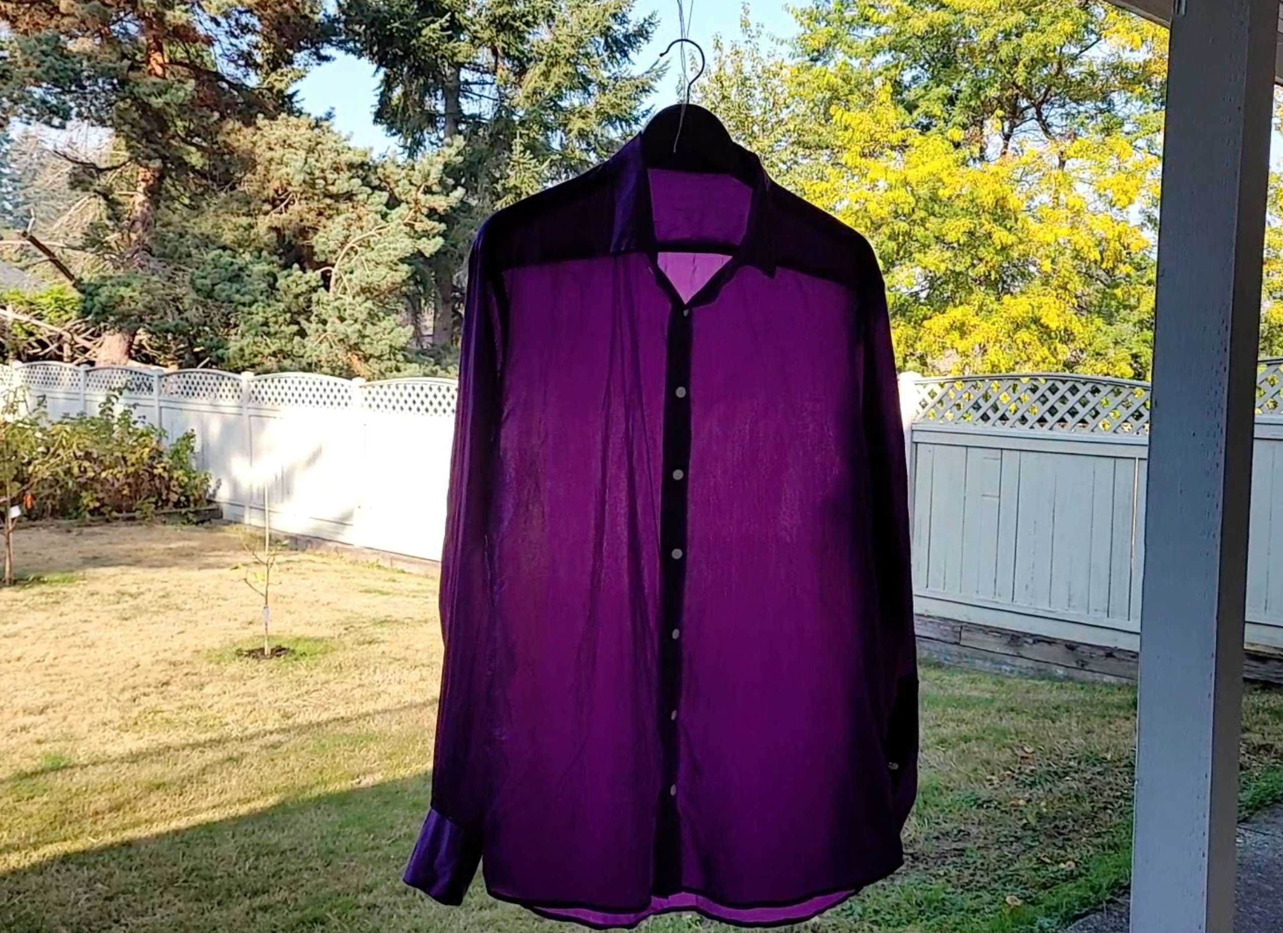 photo of a satin shirt air drying outside in the shade