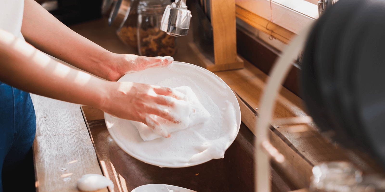 Person washing dishes.