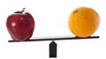 red apple on a scale with an orange - comparing apples and oranges is like comparing collagen and whey