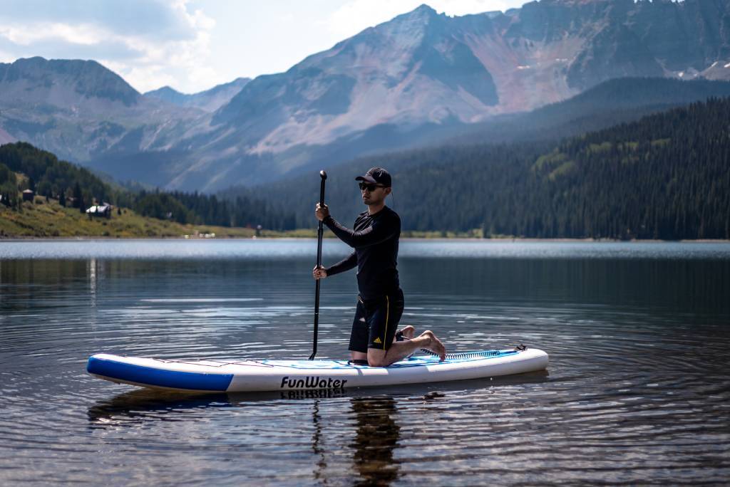 Inflatable paddle board in summer with hat