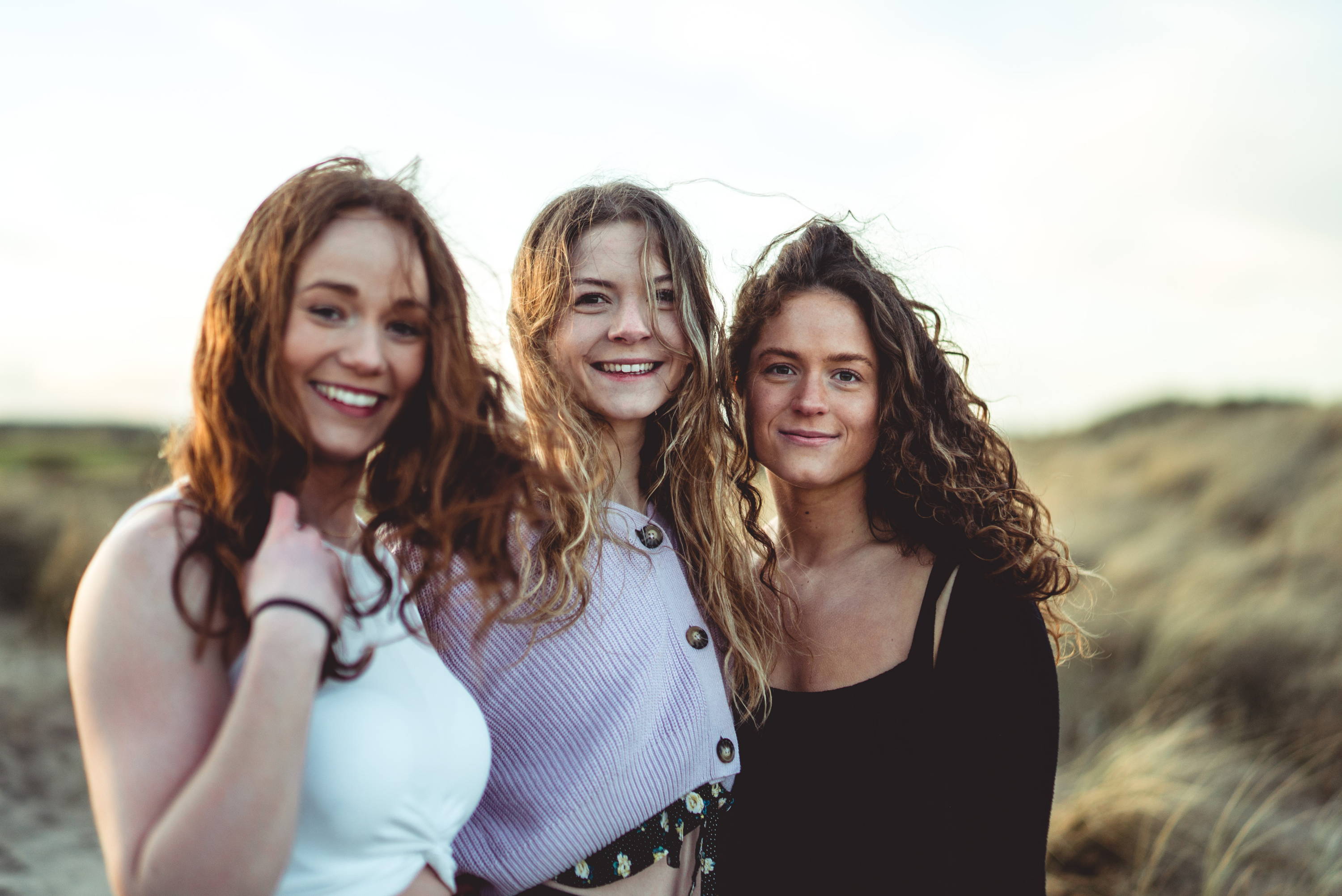 Photo of 3 girls on beach with wavy hair