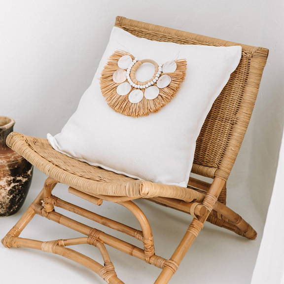 White Coastal Cushion with Shells and Raffia Decor - Ideal addition to enhance your coastal home.