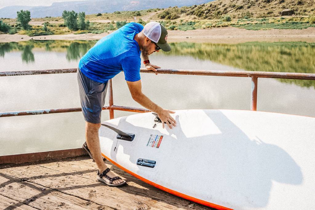 Remove paddle board fins and accessories before roll up SUP board