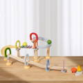 Wooden marble track toy with xylophone, balls, bell, and rings. 