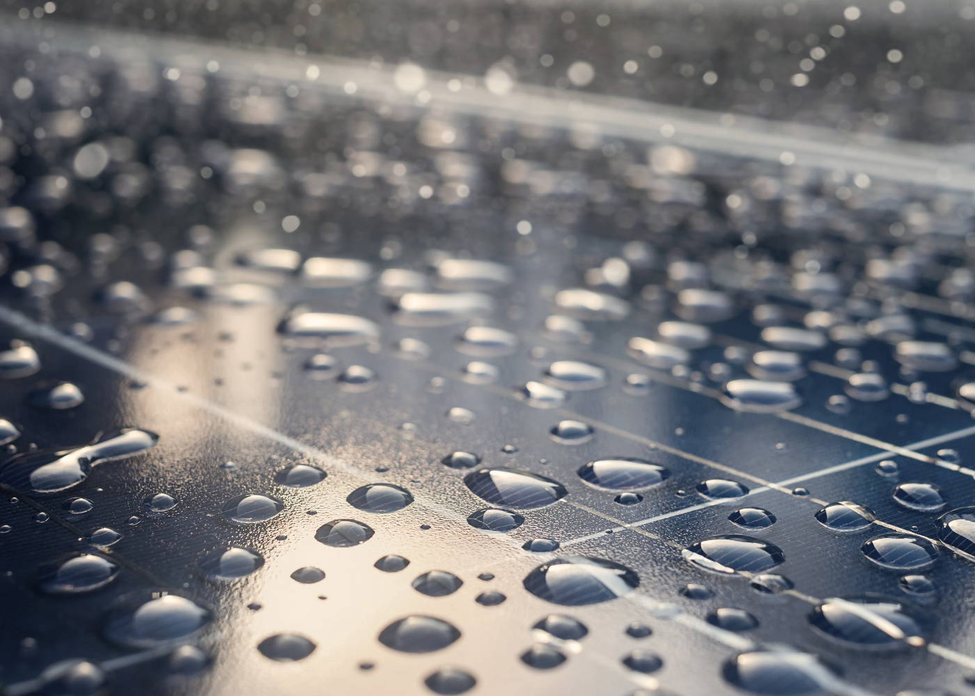 Close-up image of solar panels with water drips on them. 