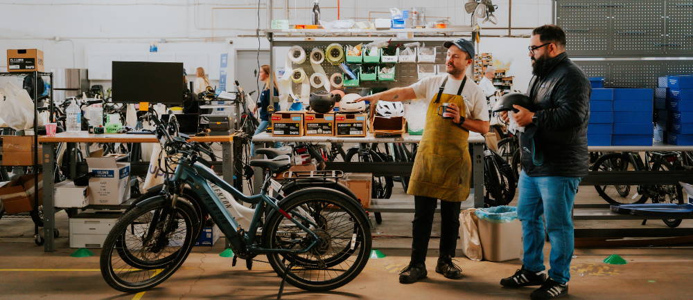 Bike mechanic talking to a customer
