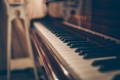 A side-long shot of the keys of an upright piano.