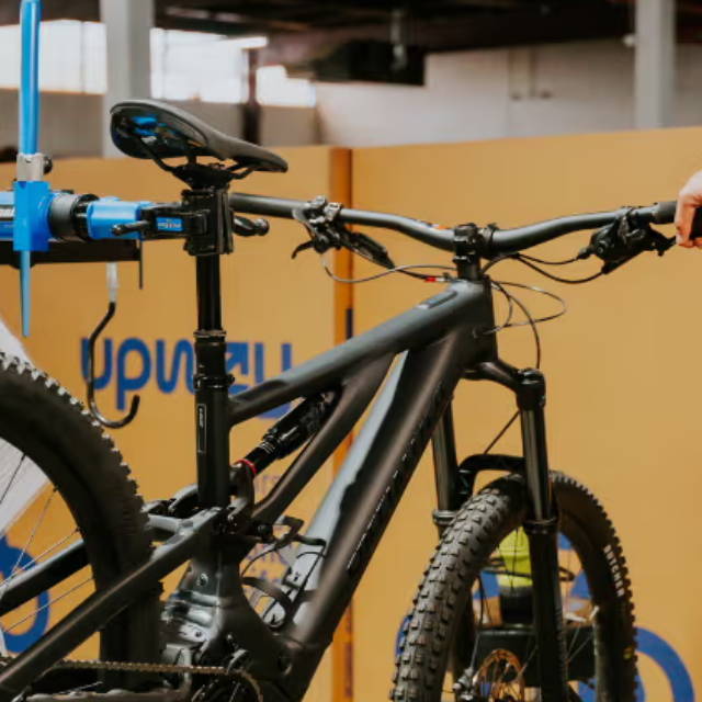 an electric mountain bike in front of an upway bike box