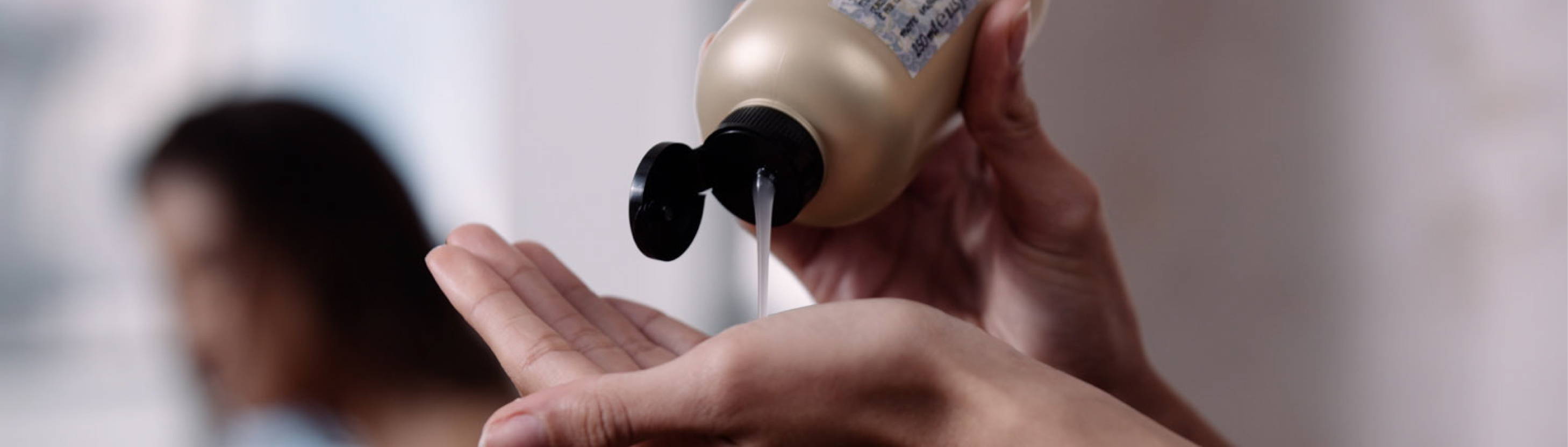 Close-up of someone using Davines This is a Curl Gel Oil