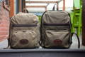both sizes of north bay daypack sitting next to eachother on a step of a patio