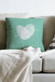 aqua pillow on couch personalized with couple's fingerprints and names