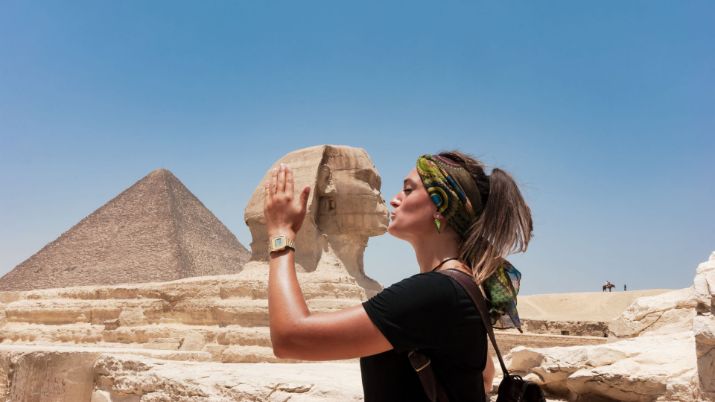 The popular pose chosen by many travelers visiting the Great Sphinx of Giza