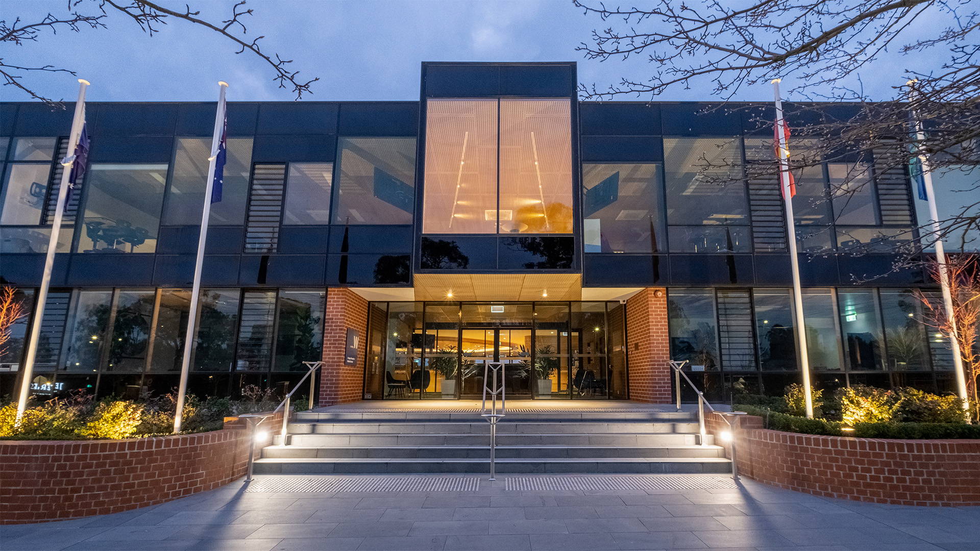 Front view of the Luther College, showcasing entry area and is illuminated by Commercial Bollard LED Lights by Havit
