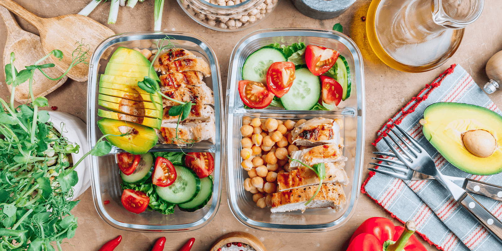 Containers holding salad and chicken.