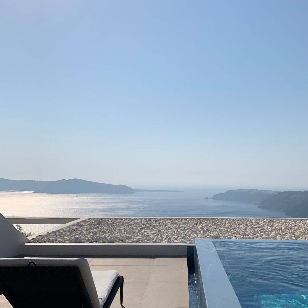 Cavotagoo infinity pool overlooking Santorini caldera at sunset