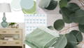green leaves, cotton throw, raffia chest and green lamp