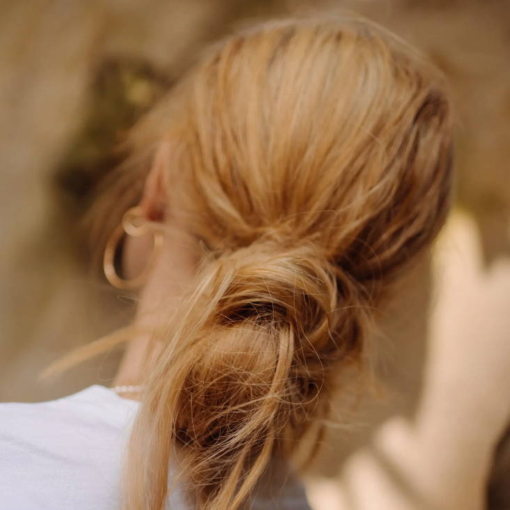 messy low bun hairstyle