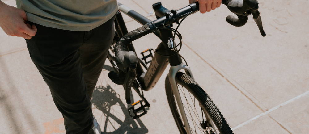 A man standing over an Bianchi e-Bike