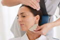 woman having a gua sha treatment on her face