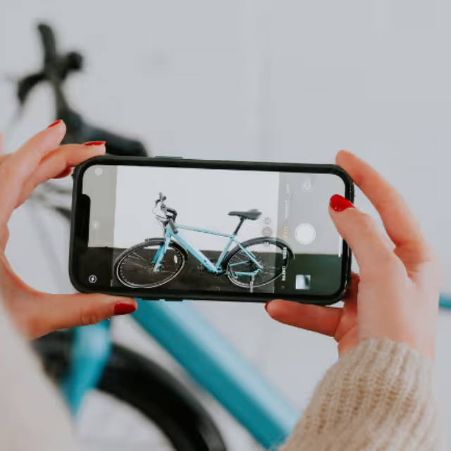 Woman taking photo of electric bike on iphone