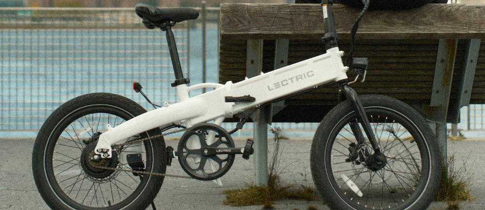 Lectric folding bike against a bench