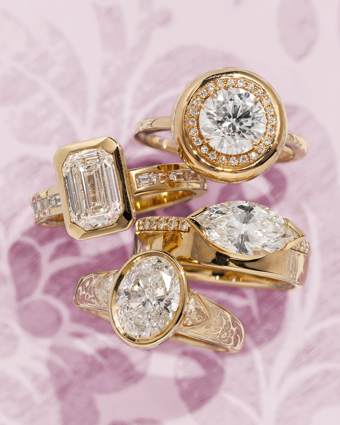 Diamond engagement rings in various sizes stacked on top of each other in a lifestyle image