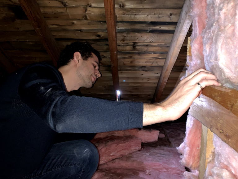 inspecting home insultation to find ways to reduce electric bill