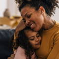 Mother and daughter hugging.