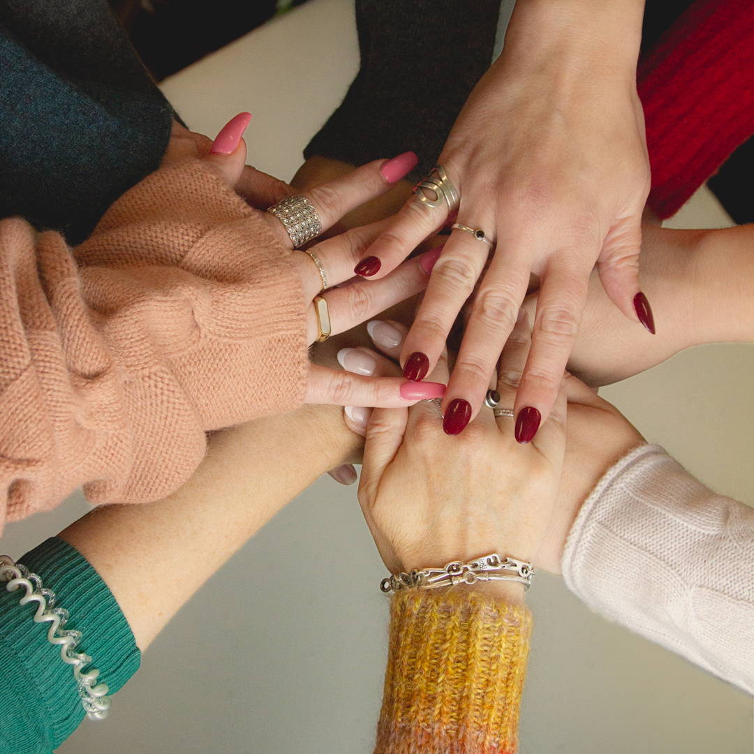 Margaret O'Leary corporate staff in a team huddle.