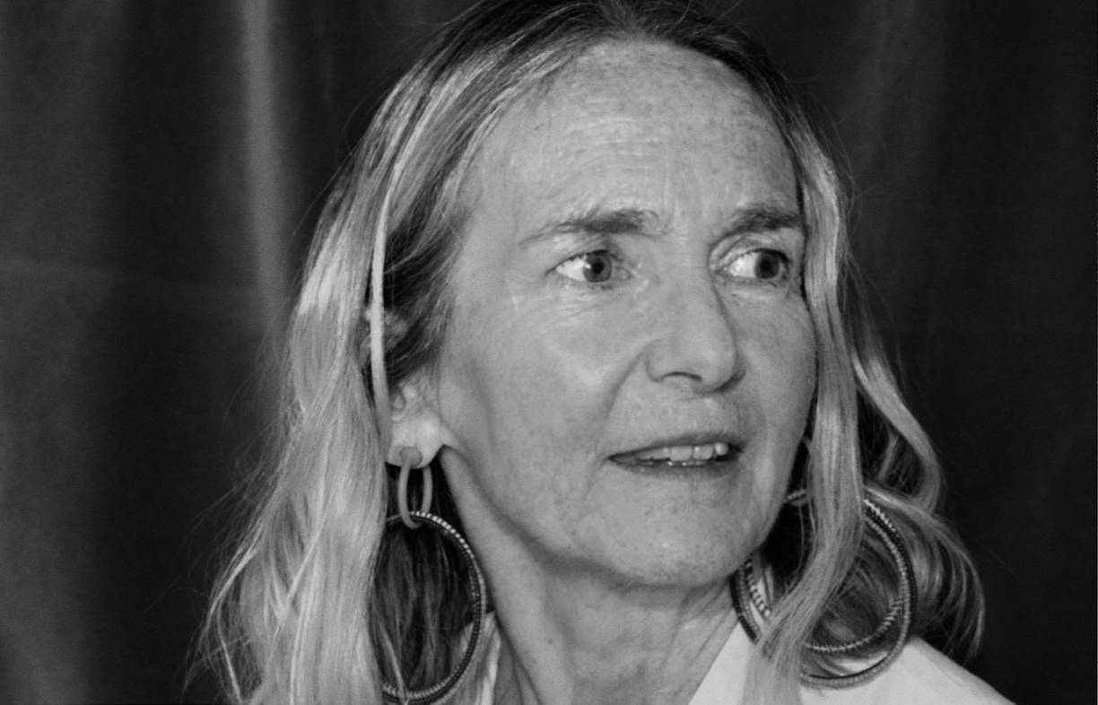 Black and white photo of Alison looking over her shoulder with a slight smile