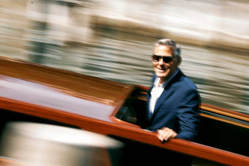 Image may contain: George Clooney, Face, Head, Person, Photography, Portrait, Accessories, Sunglasses, Clothing, and Coat