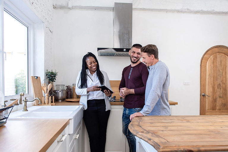 a couple walking through a home with their realtor