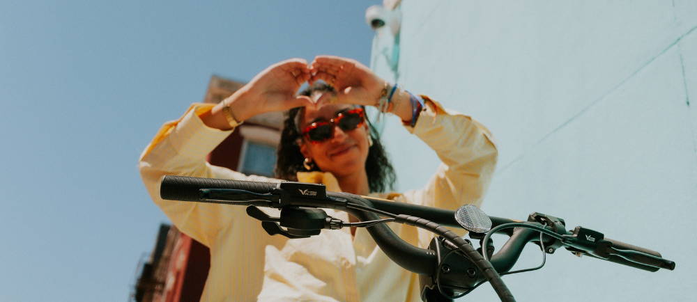 Woman making a heart on Specialized Globe Haul cargo ebike