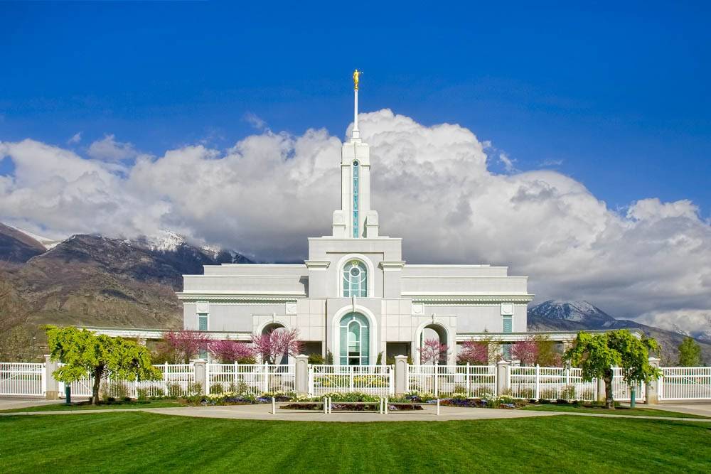 LDS art photo of the Mount Timpanogos Temple against a summer sky and mountains with freshly-cut grass.