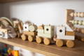 A Montessori inspired wooden train toy on a shelf.