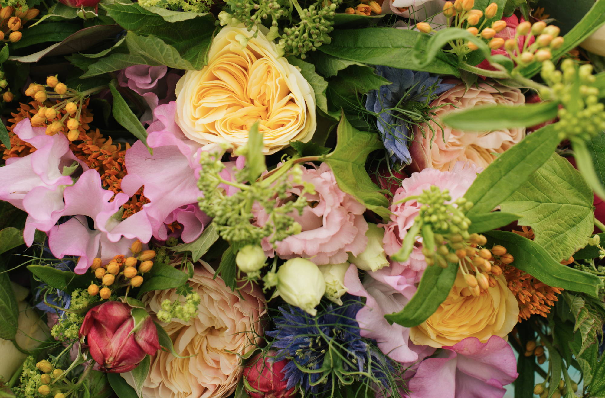 Wild at Heart Foundation Bouquet, featuring vuvuzela roses, lisianthus and clematis