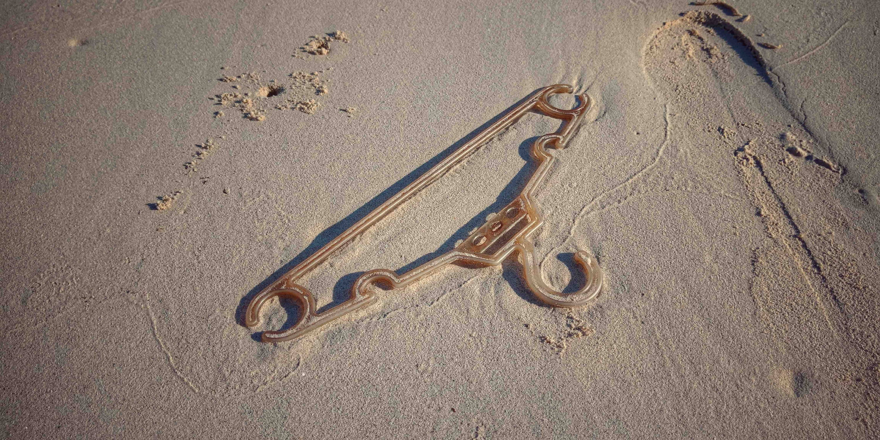 Plastic hanger on beach Plastic hanger on beach
