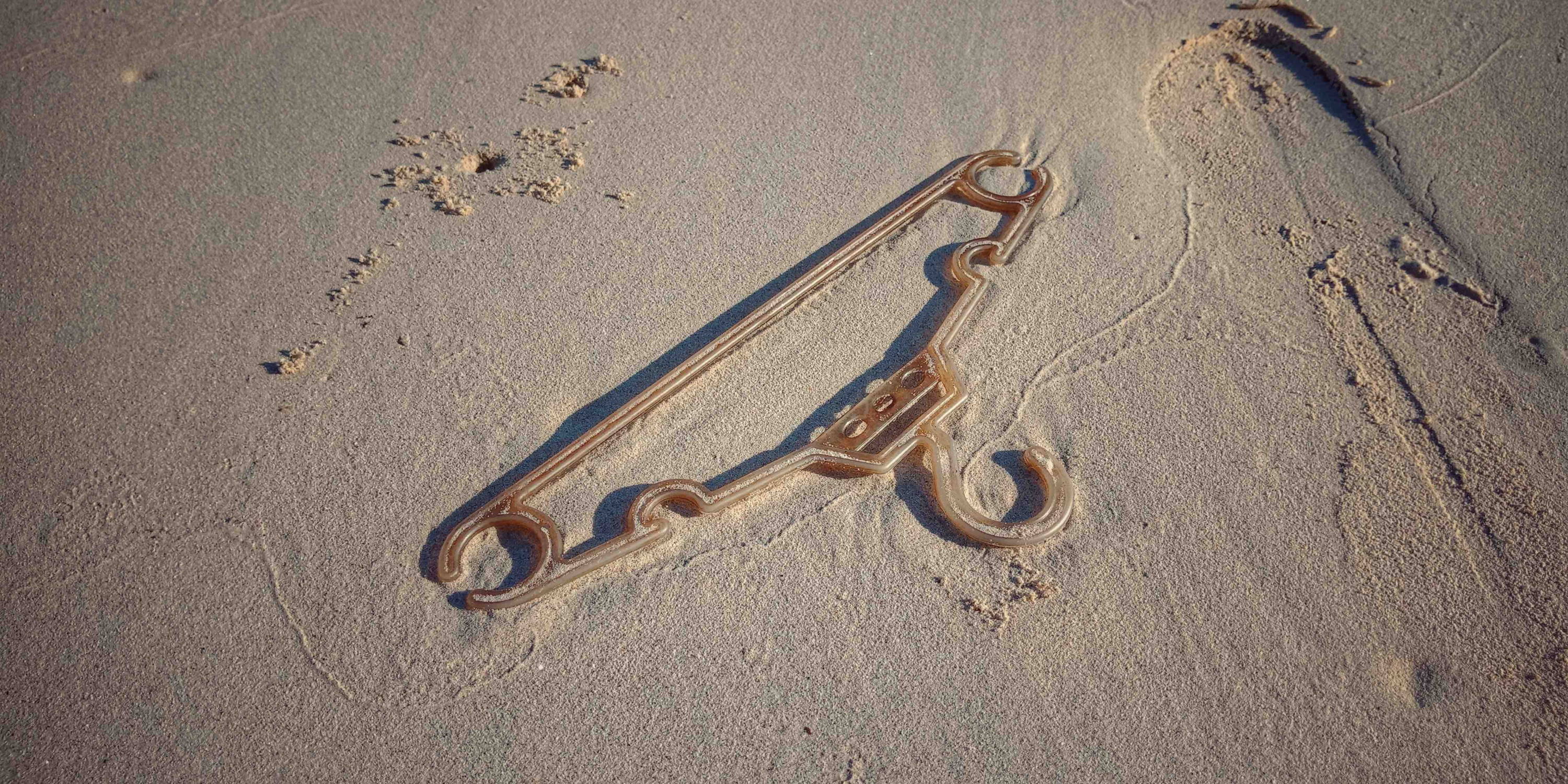 Plastic hanger on beach