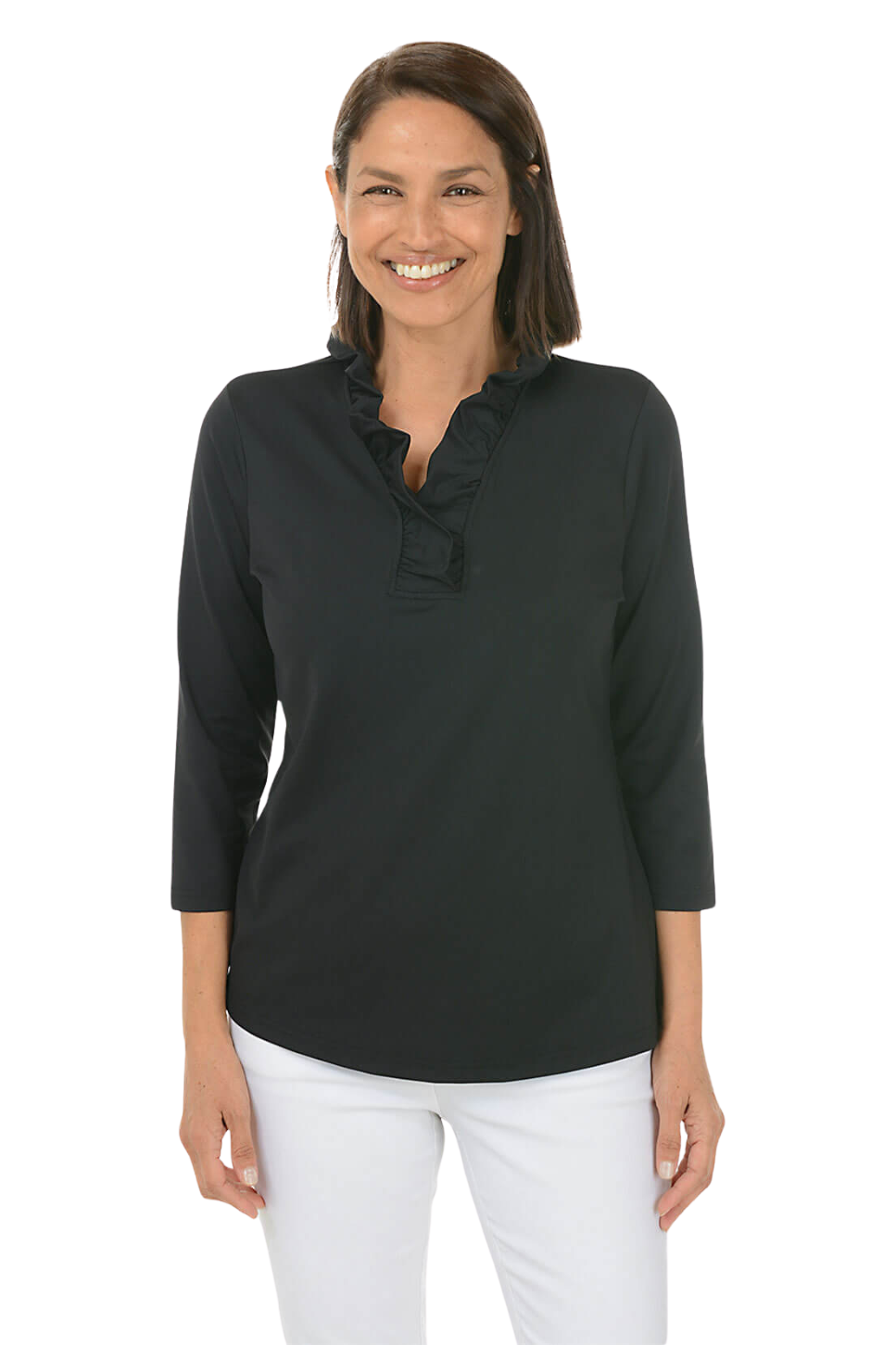 A woman wearing a black top and white pants against a beige background