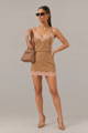 Model in a camel lace-trim cami and mini skirt set with a tan handbag - Fall Sets