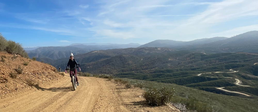 a woman riding telegraph hill rd in midpines, california