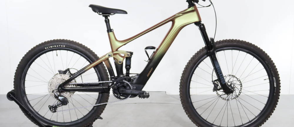 a black and gold Giant Trance X Advanced E+ Elite 3 full suspension electric mountain bike
