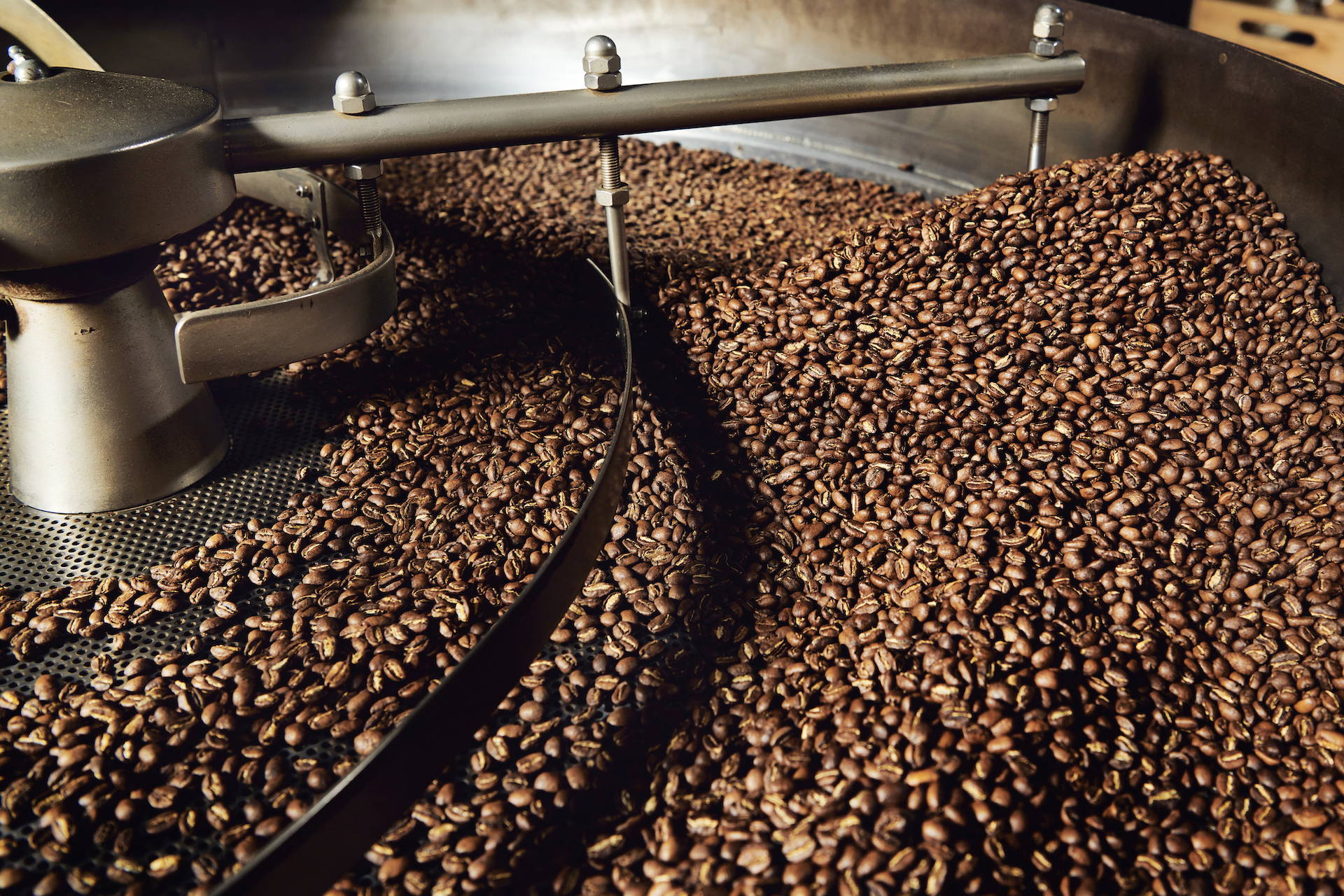 Large amount of coffee beans spinning around in a roaster