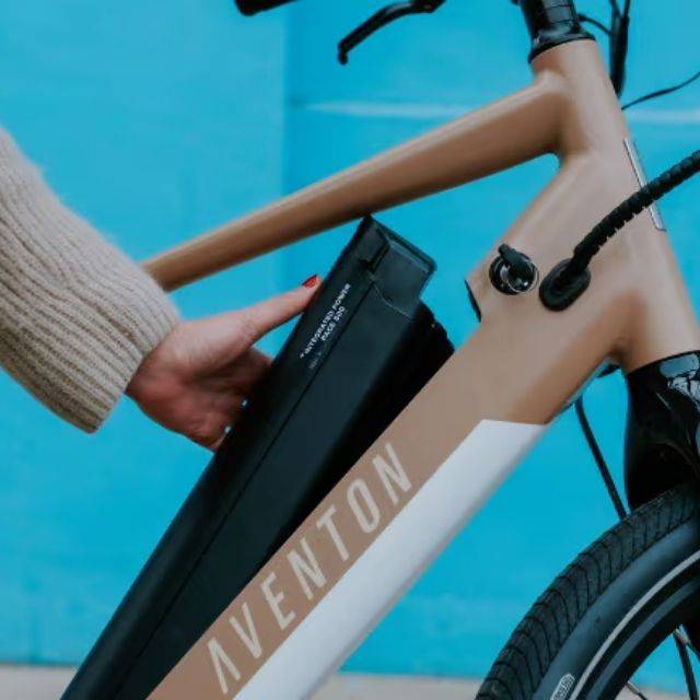 Close up of someone removing an Aventon e-bike battery