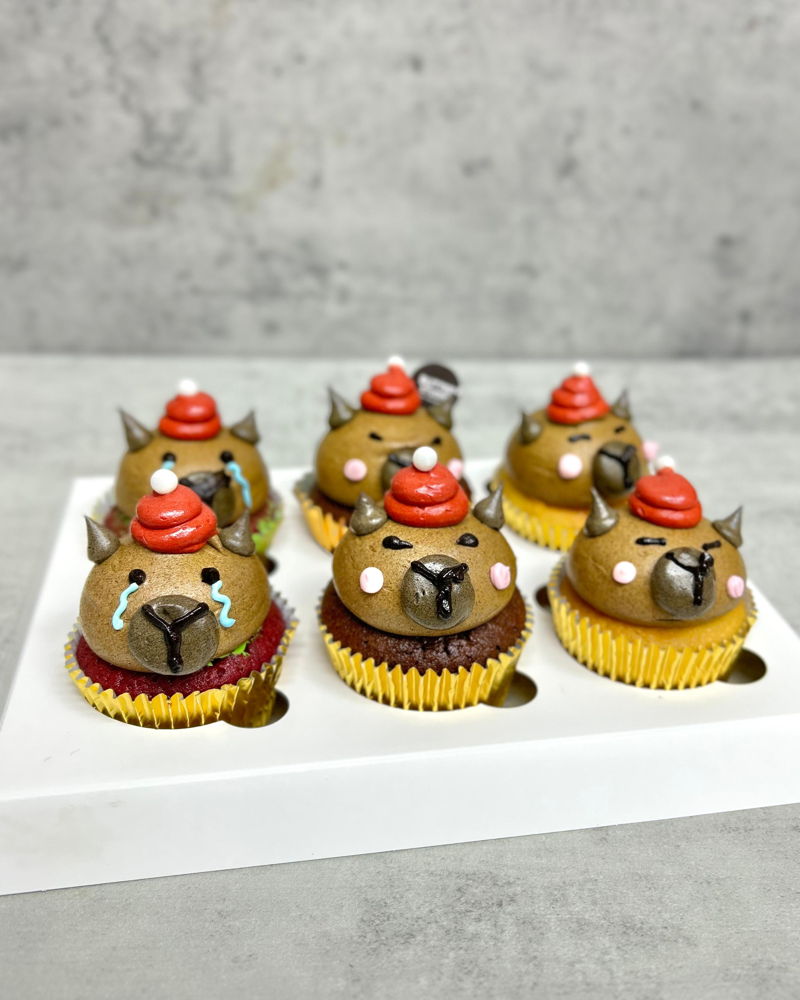 Christmas Capybara Cupcakes in Santa hats