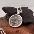 a fingerprint necklace pendant in silver
